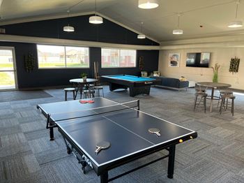 a games room with a ping pong table and a foosball table  at Courtyard Apartments, Moorhead, 56560